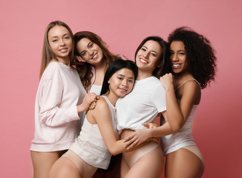 Photo of Group of women with different body types in underwear on pink background