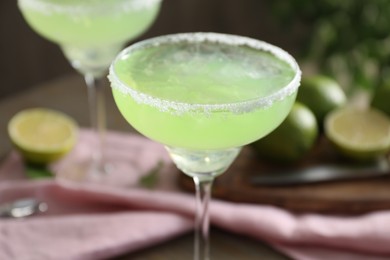 Delicious Margarita cocktail in glasses on table, closeup