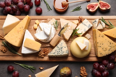 Photo of Flat lay composition with different types of delicious cheese on table