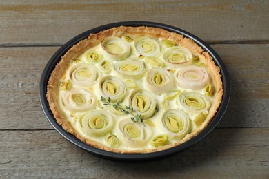 Photo of Tasty leek pie with thyme on wooden table