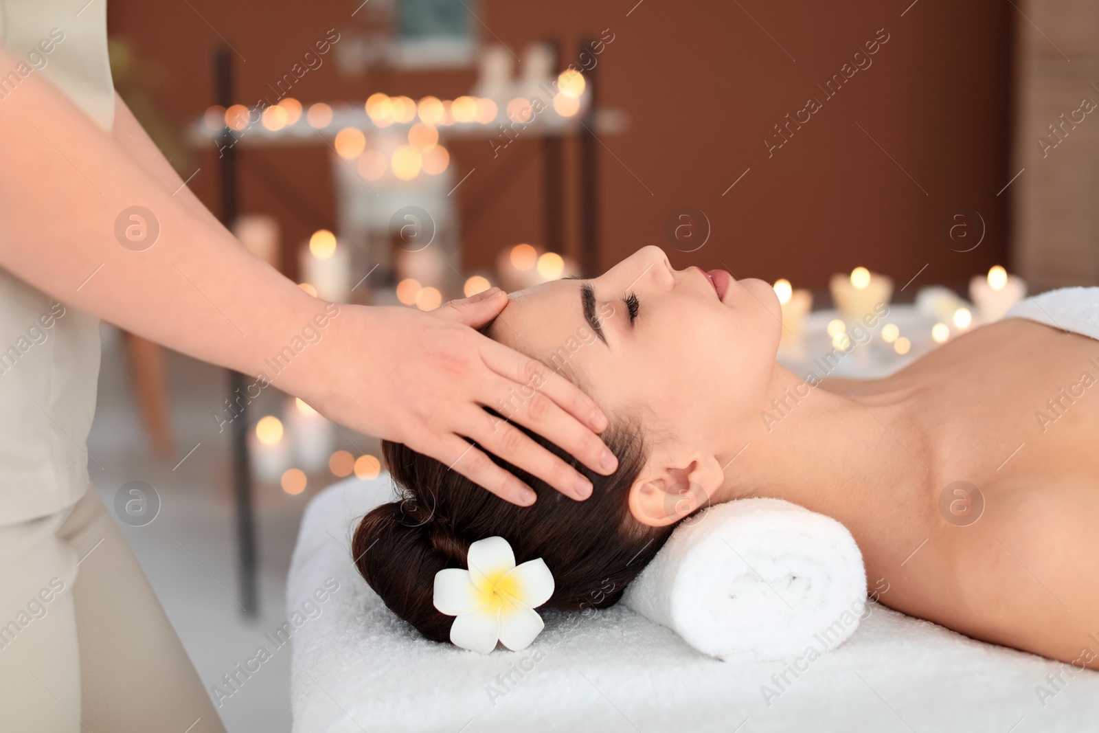 Photo of Young woman receiving massage in spa salon