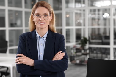 Happy real estate agent indoors. Space for text