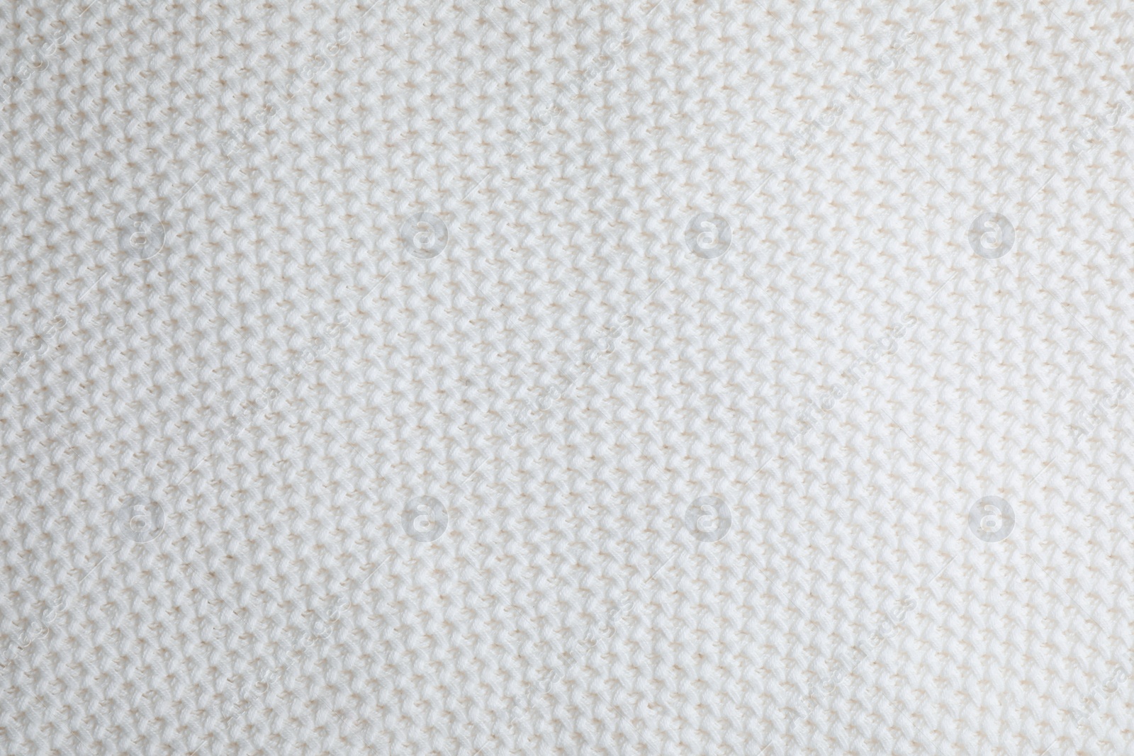 Photo of White knitted sweater as background, closeup view