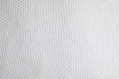 White knitted sweater as background, closeup view