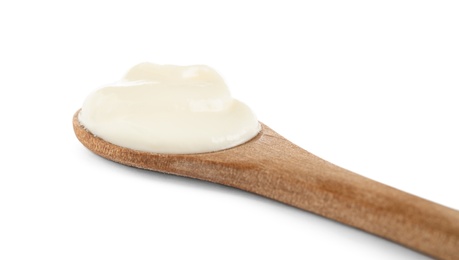 Photo of Wooden spoon with sour cream on white background