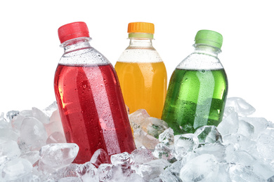 Photo of Ice cubes and different soda drinks on white background