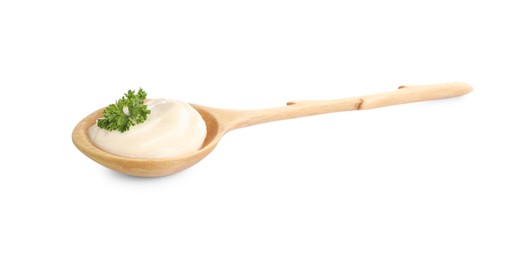 Wooden spoon with tasty mayonnaise and parsley isolated on white