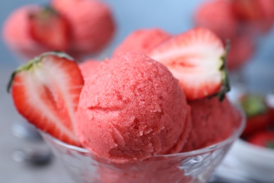 Photo of Delicious strawberry ice cream with fresh berry in dessert bowl, closeup