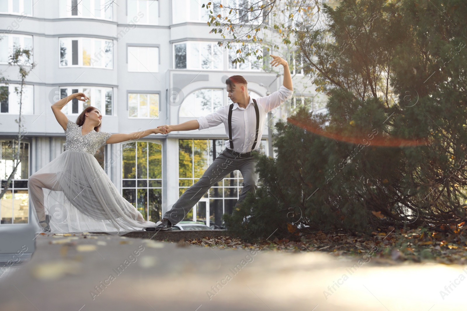 Photo of Beautiful young couple practicing dance moves outdoors