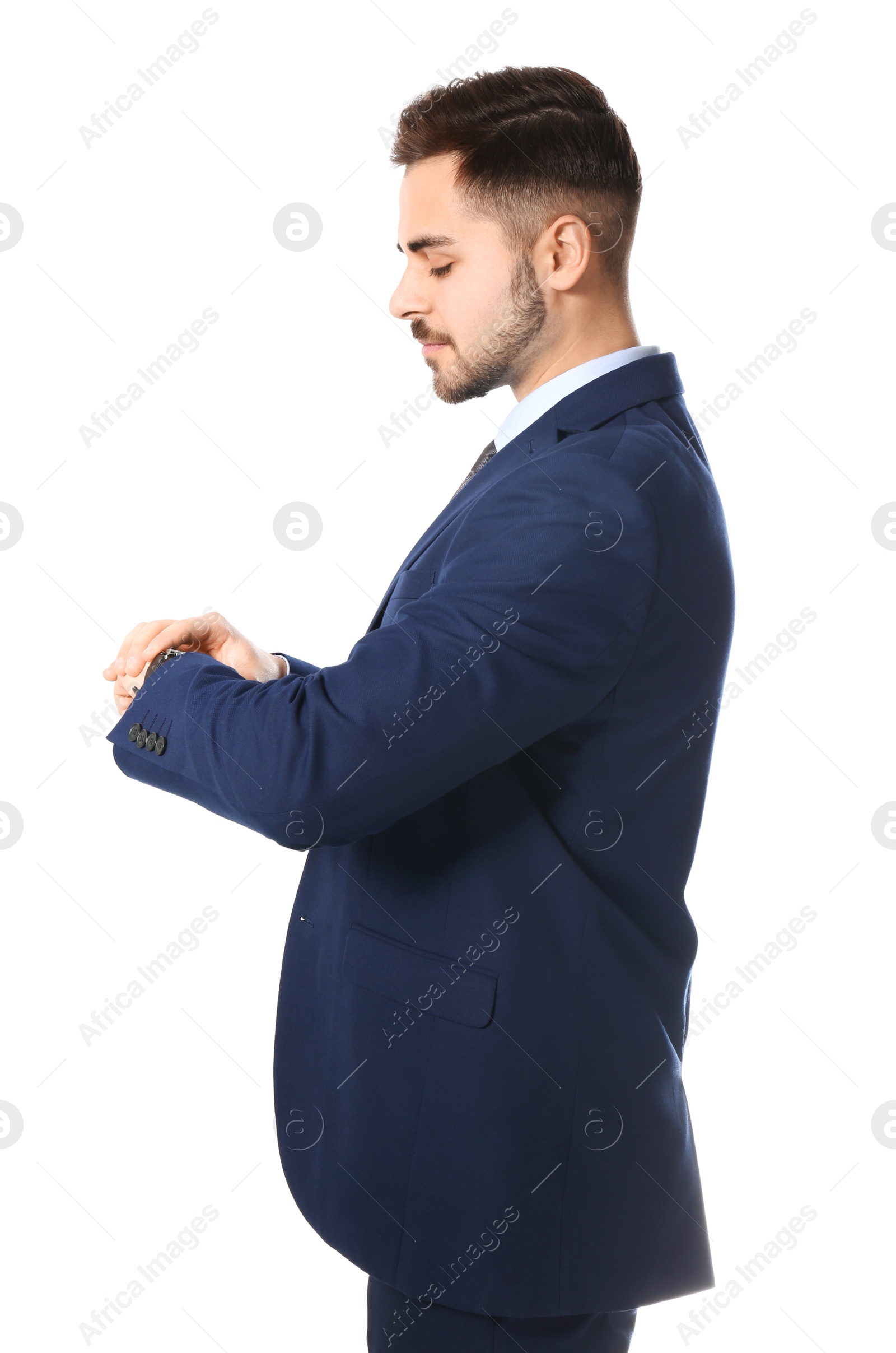 Photo of Portrait of businessman looking at wrist watch on white background