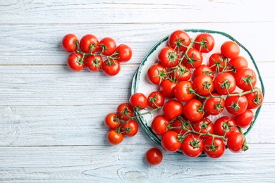 Flat lay composition with ripe tomatoes on wooden background