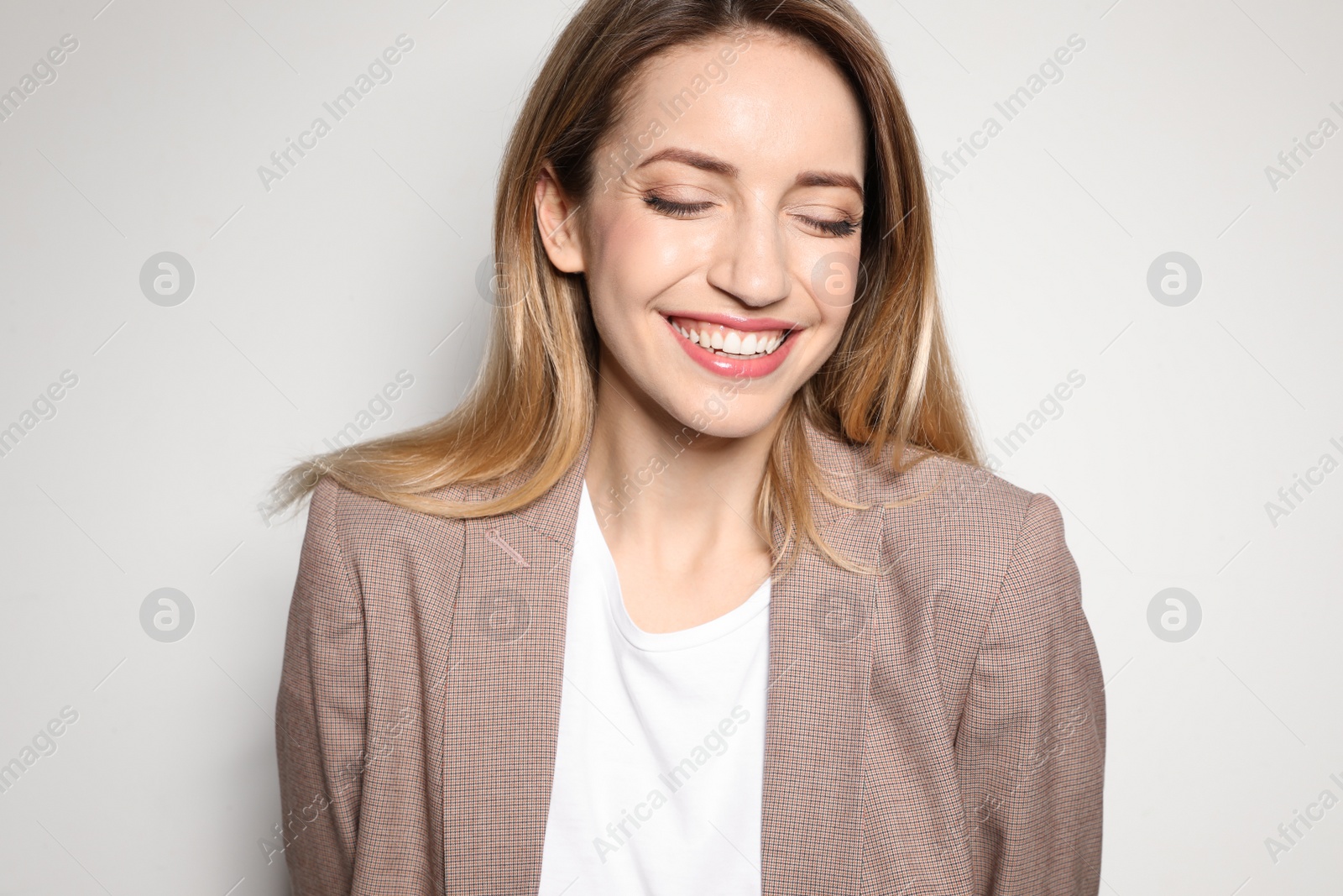 Photo of Portrait of young woman with beautiful face on light background