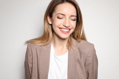 Portrait of young woman with beautiful face on light background