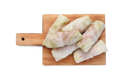 Photo of Wooden board with Uncooked stuffed cabbage rolls isolated on white, top view