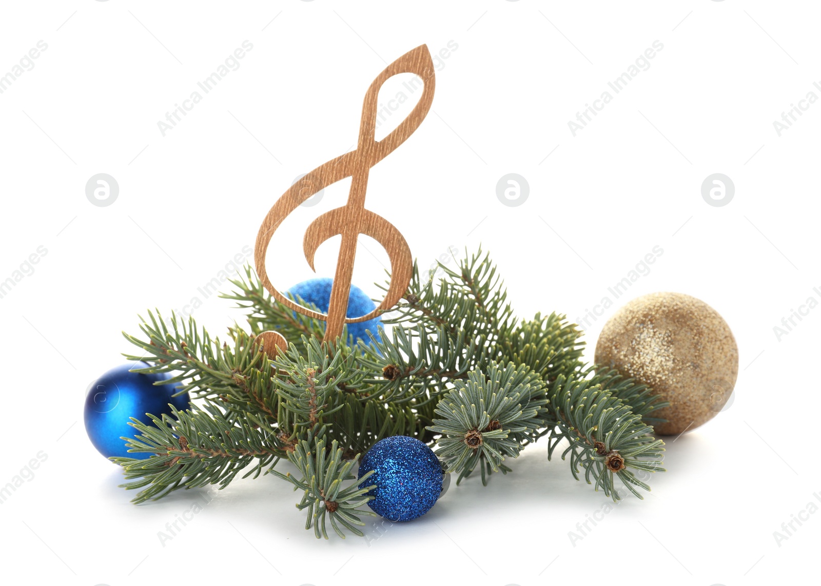 Photo of Composition with wooden treble clef, balls and fir tree branches on white background. Christmas music concept