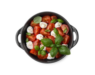 Tasty salad Caprese with mozarella balls, tomatoes and basil on white background, top view
