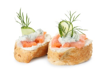 Photo of Tasty canapes with salmon, cucumber, cream cheese and dill isolated on white