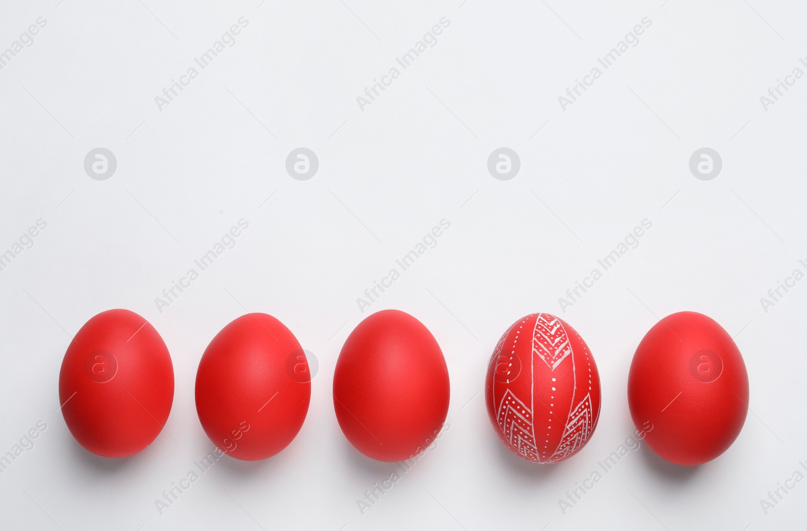 Photo of Composition of painted red Easter eggs on white background, top view