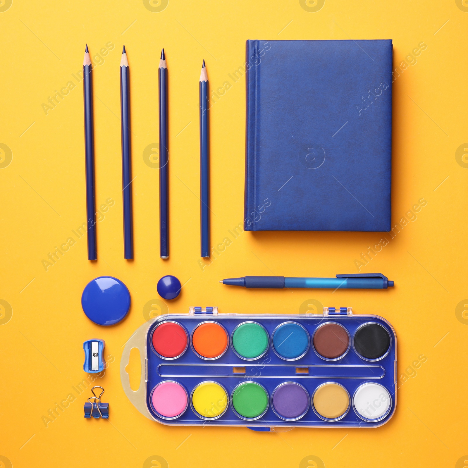 Photo of Different stationery on orange background, flat lay