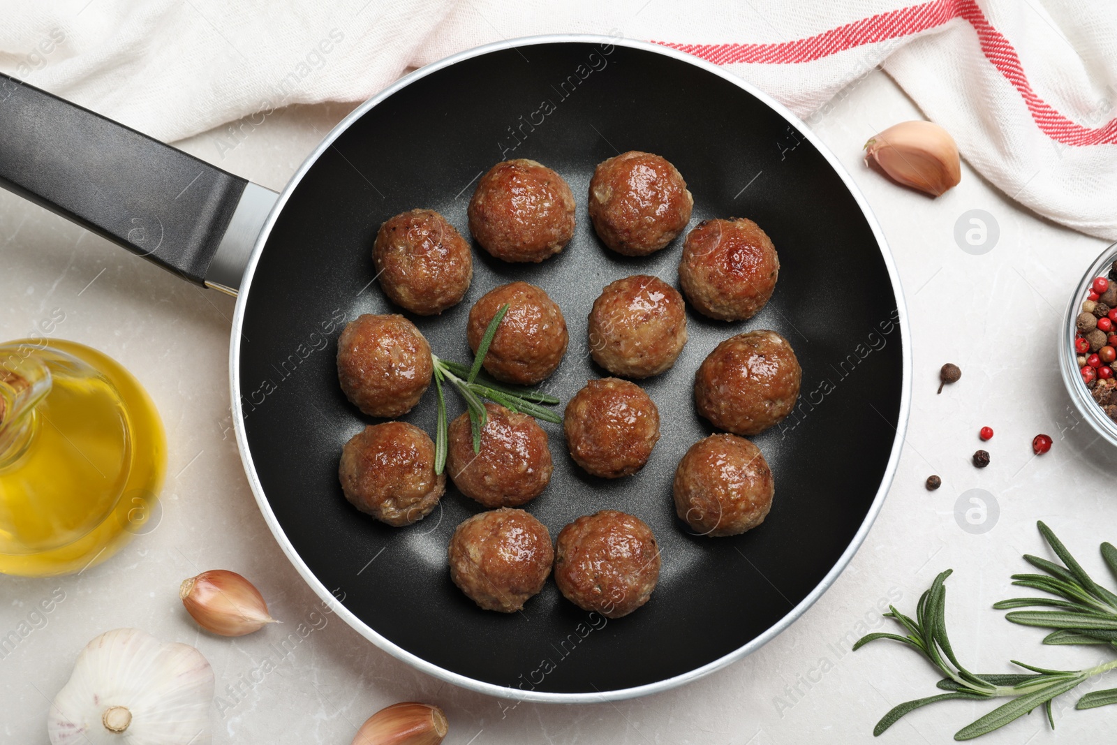 Photo of Tasty cooked meatballs on light grey marble table, flat lay