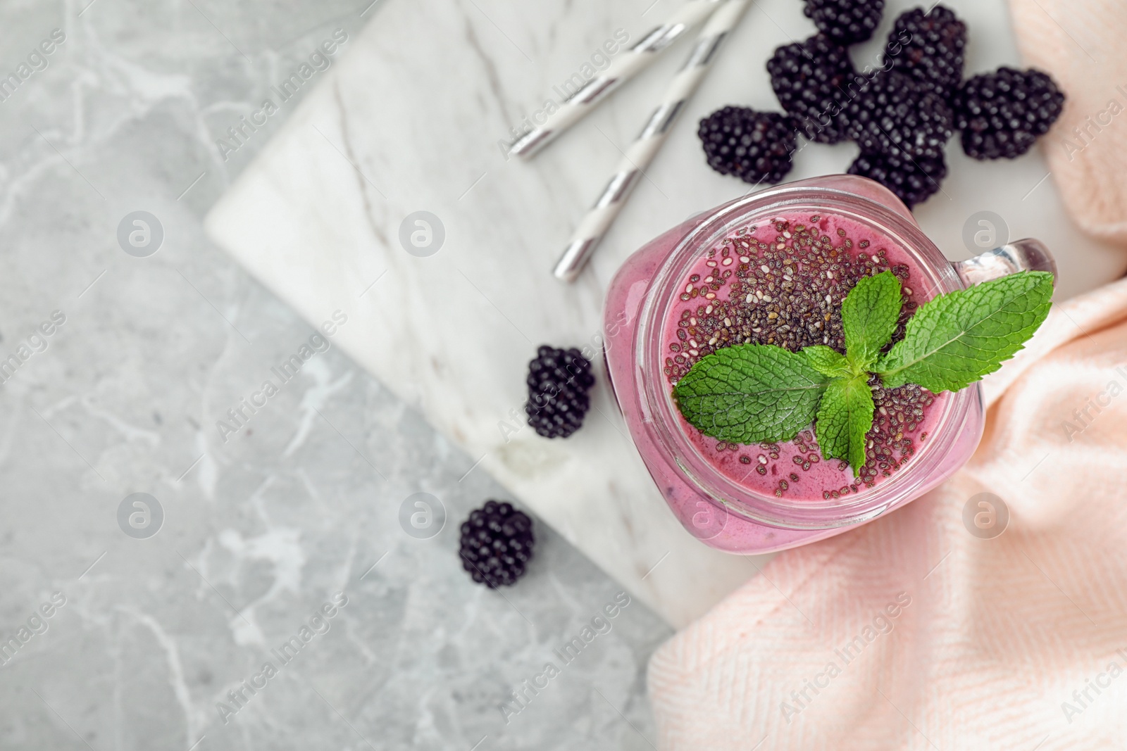 Photo of Flat lay composition with delicious blackberry smoothie on marble background. Space for text