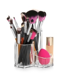 Set of makeup cosmetic products in organizer on white background