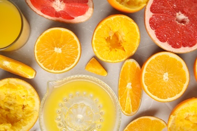 Flat lay composition with oranges and squeezer on light table