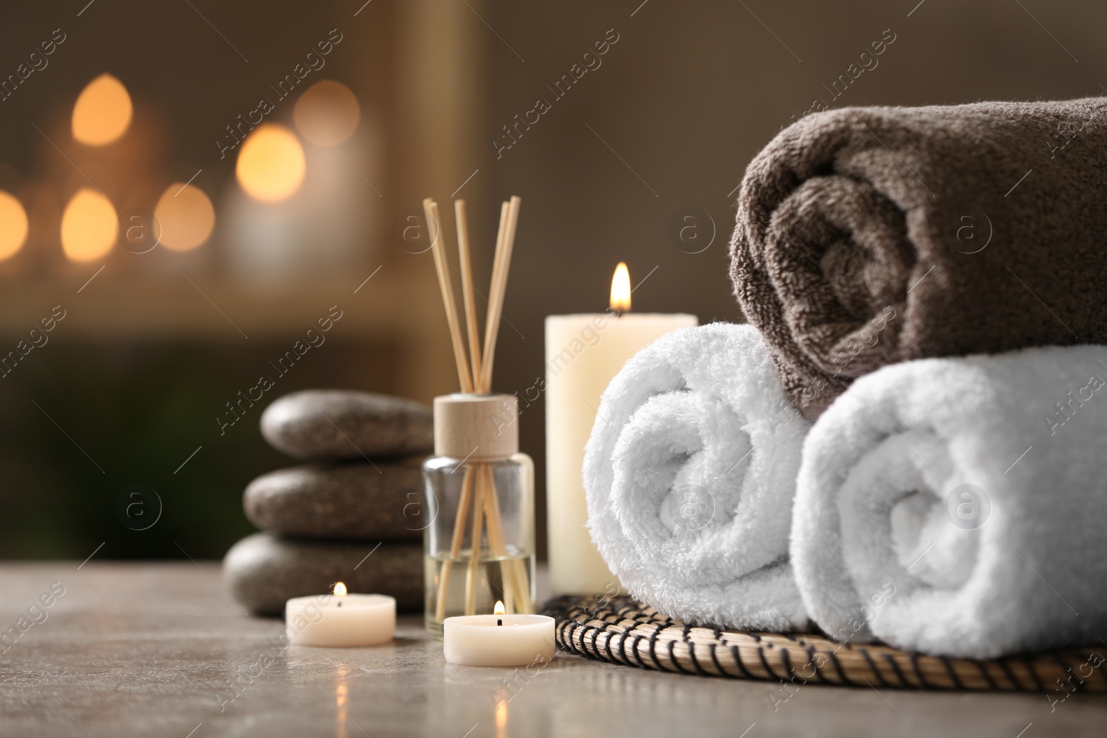 Photo of Beautiful composition with spa stones on grey marble table, closeup