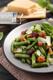 Photo of Delicious salad with green beans, mushrooms and cheese on wooden table, closeup