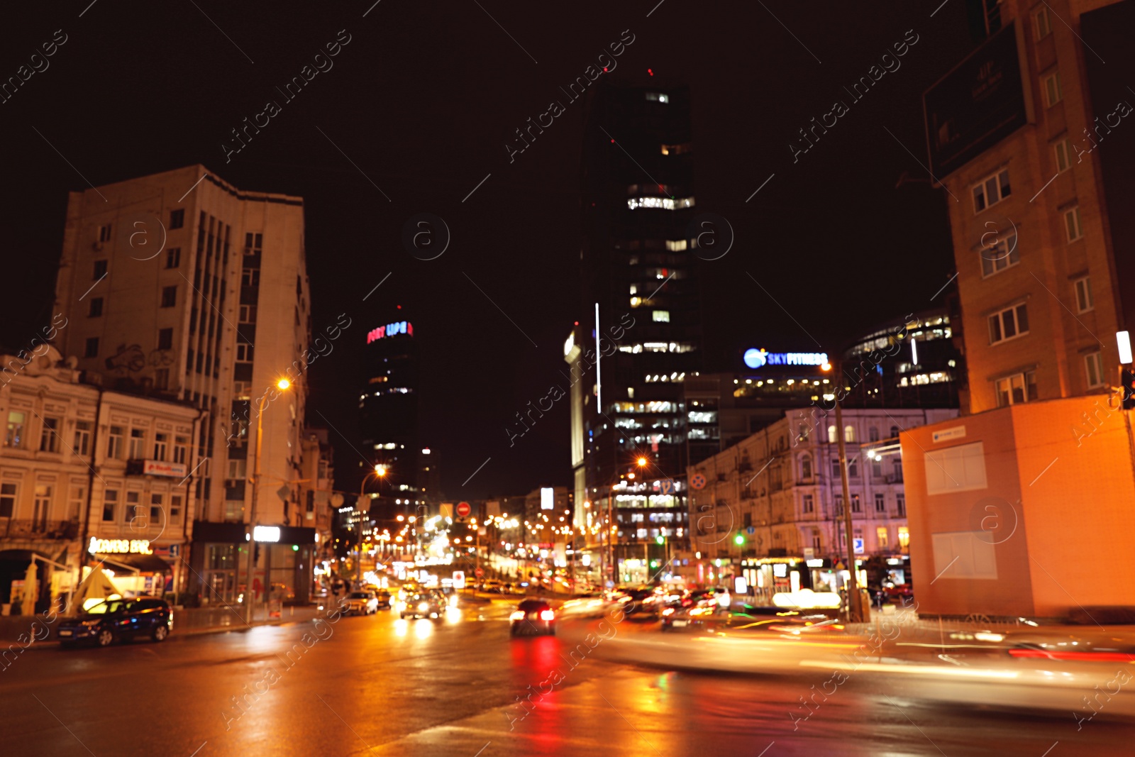 Photo of KYIV, UKRAINE - MAY 22, 2019: View of night city with illuminated buildings and road traffic