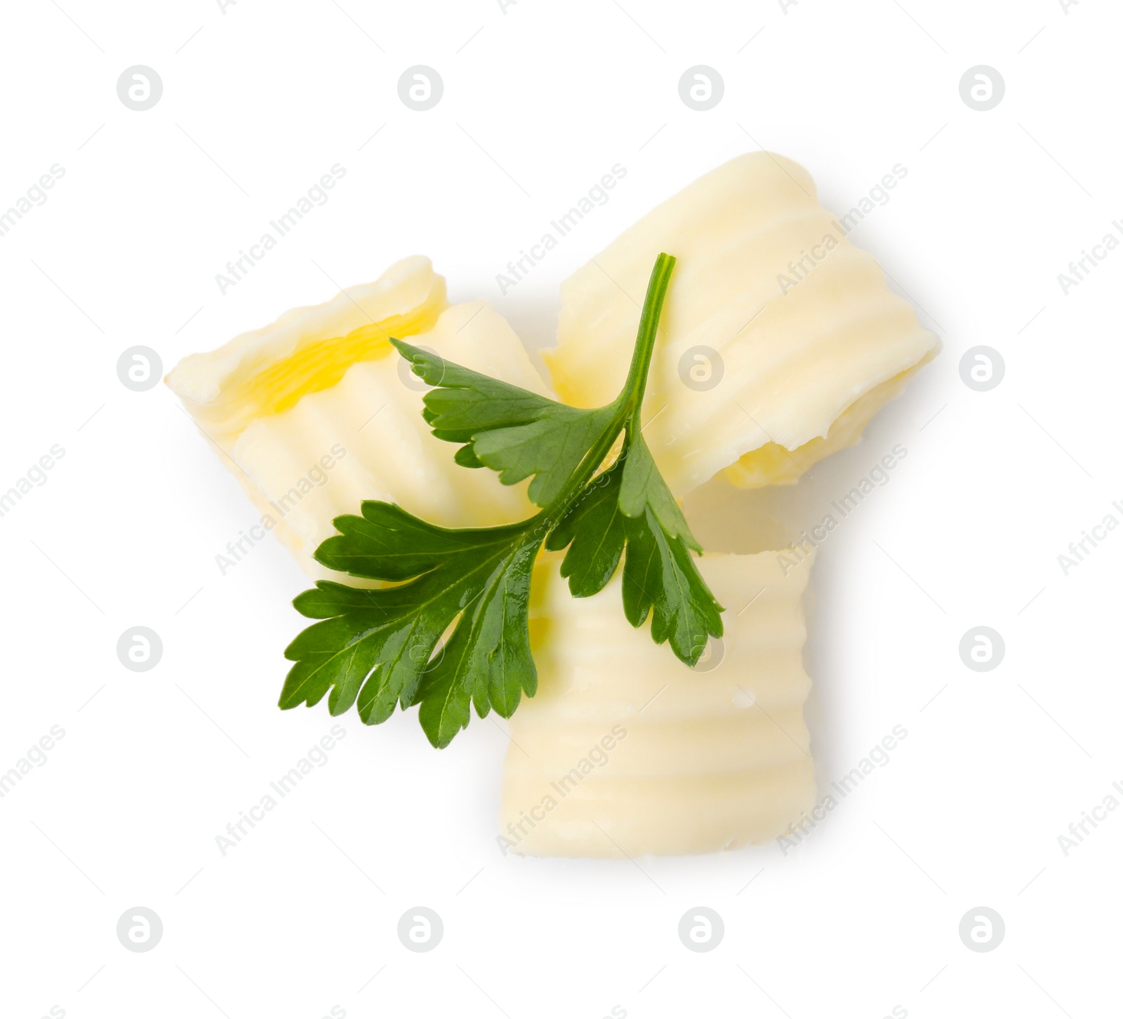 Photo of Tasty butter curls and fresh parsley isolated on white, top view