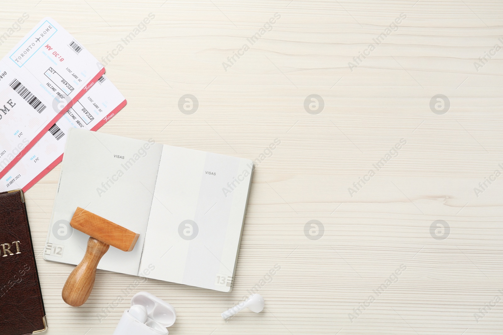 Photo of Flat lay composition with passports, stamp and flight tickets on wooden table, space for text