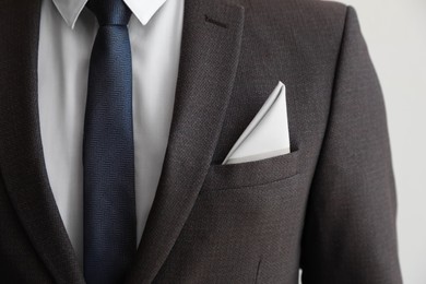 Photo of Man with handkerchief in suit pocket on white background, closeup