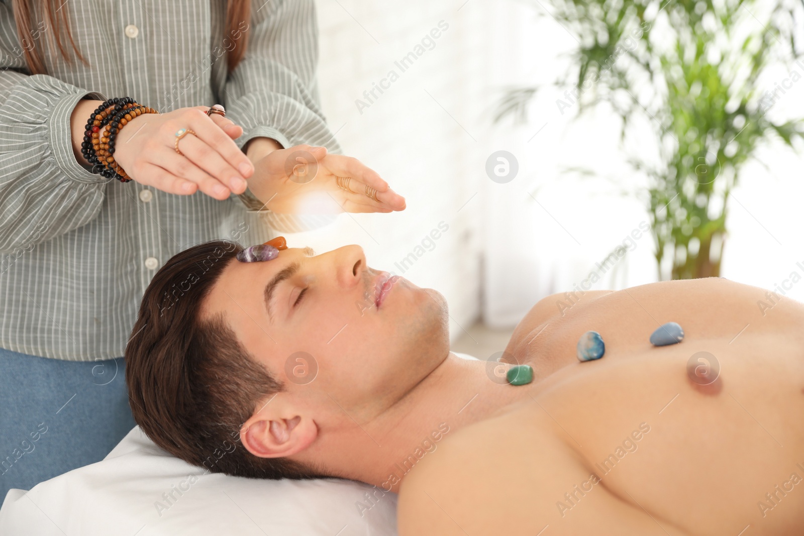 Photo of Man during crystal healing session in therapy room