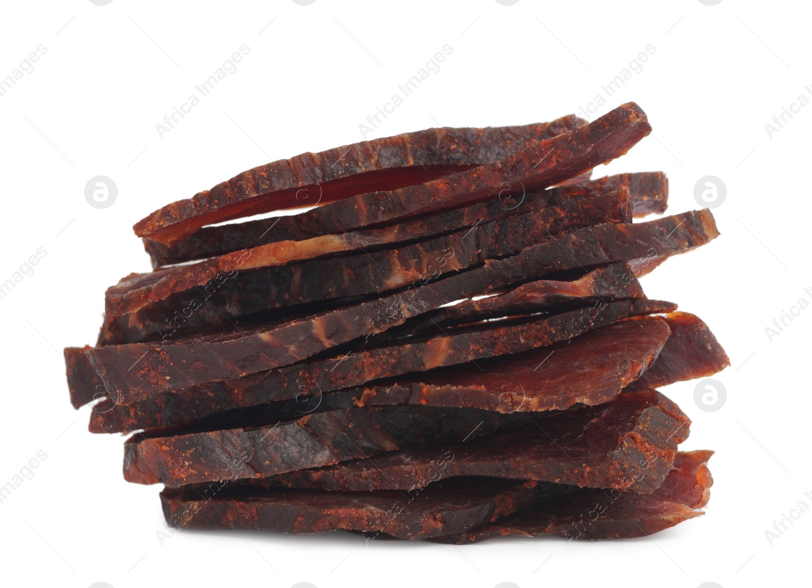 Photo of Pieces of delicious beef jerky on white background