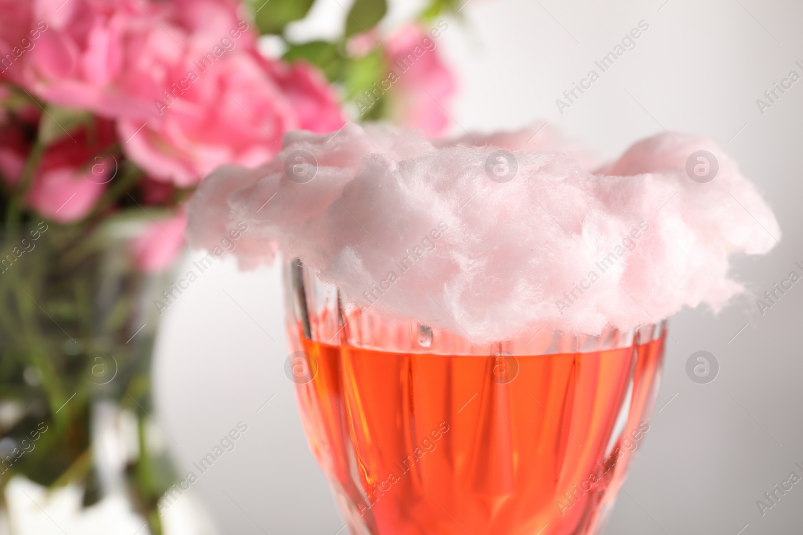 Photo of Cotton candy cocktail in glass against blurred background, closeup