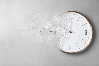 Image of Time is running out. Clock vanishing on light background