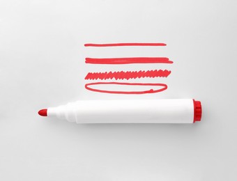 Photo of Different stripes and ellipse drawn with red marker isolated on white, top view