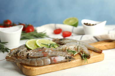 Fresh raw shrimps on white wooden table