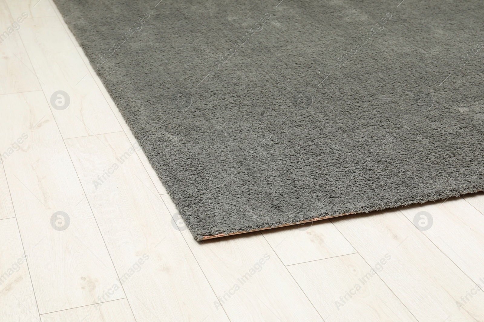 Photo of Soft grey carpet on white laminated floor indoors