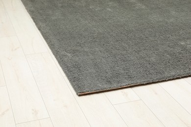 Soft grey carpet on white laminated floor indoors