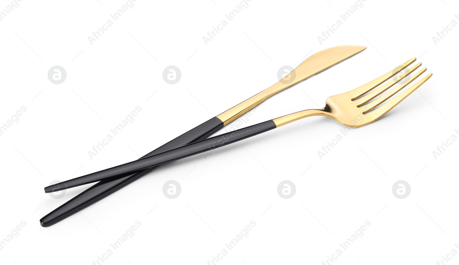 Photo of Shiny golden fork and knife isolated on white. Luxury cutlery