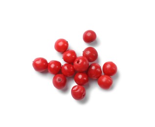 Photo of Aromatic spice. Many red peppercorns isolated on white, top view