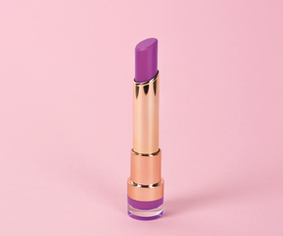 Image of Bright lipstick on pink background. Professional makeup product