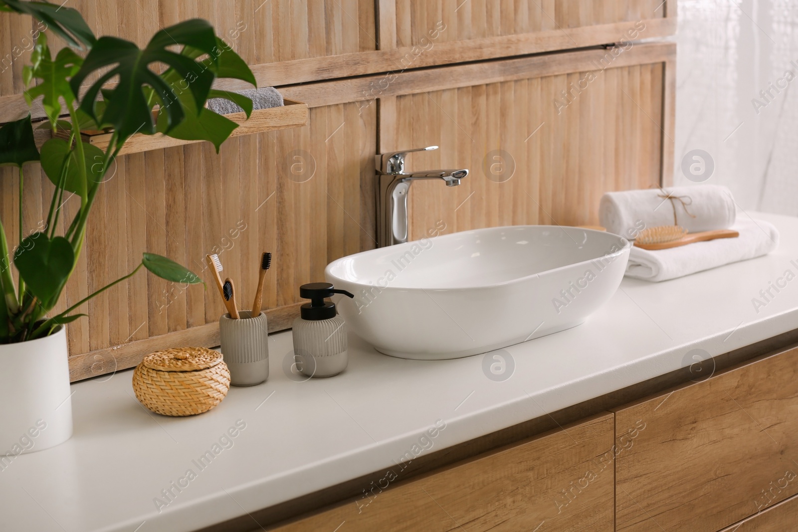 Photo of Stylish vessel sink near wooden wall in modern bathroom