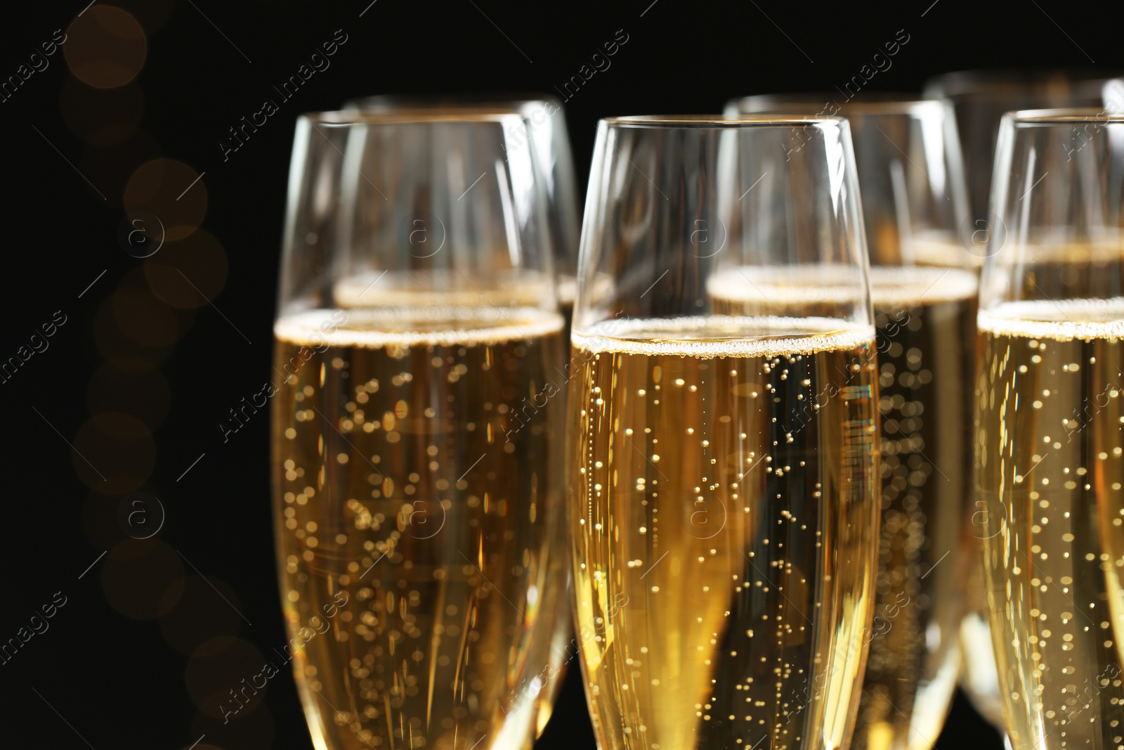 Photo of Glasses of champagne on dark background, closeup