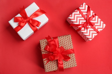 Photo of Beautifully decorated gift boxes on color background, top view