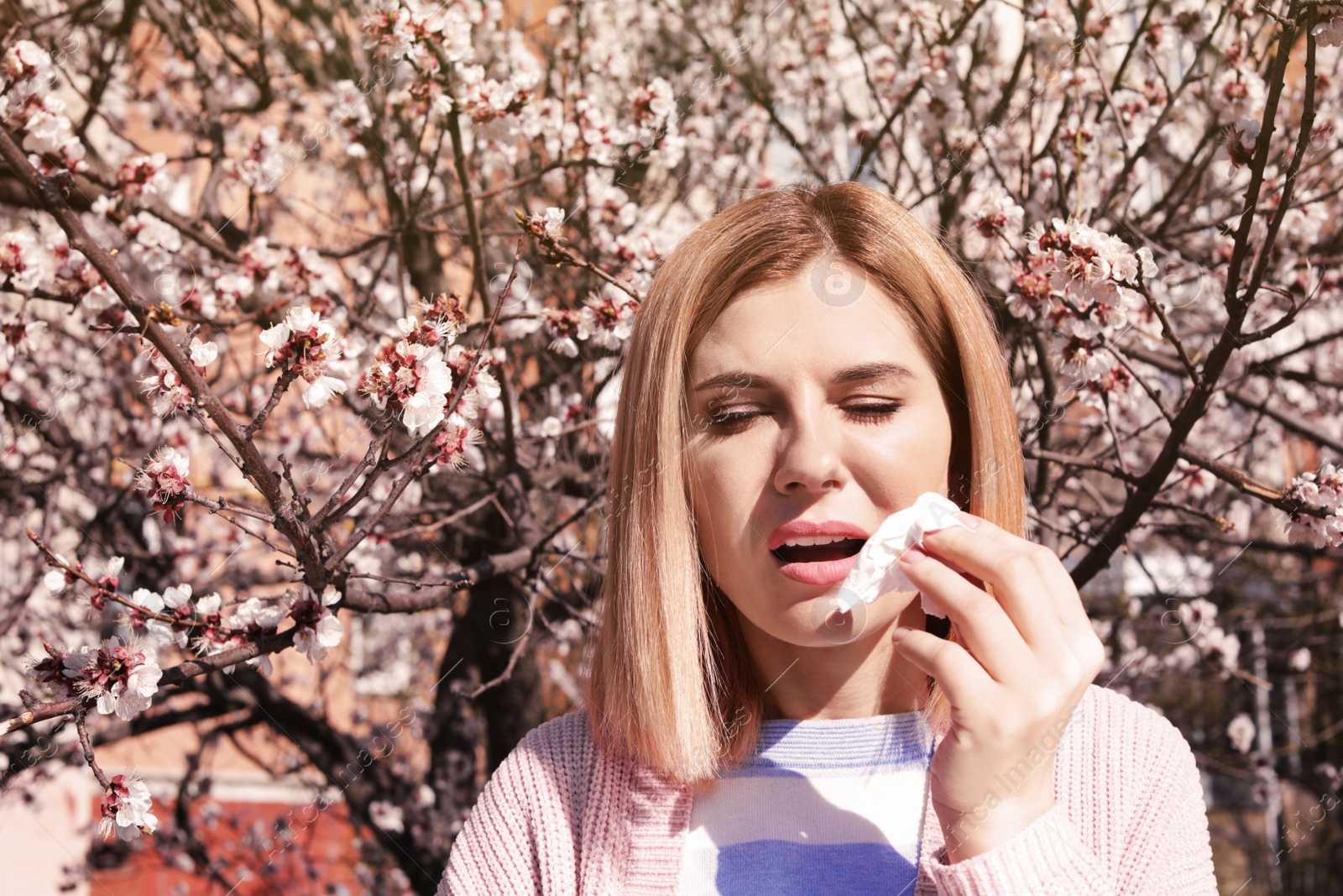 Photo of Woman suffering from seasonal allergy outdoors, space for text