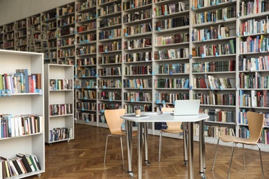 Photo of View of bookshelves and table in library