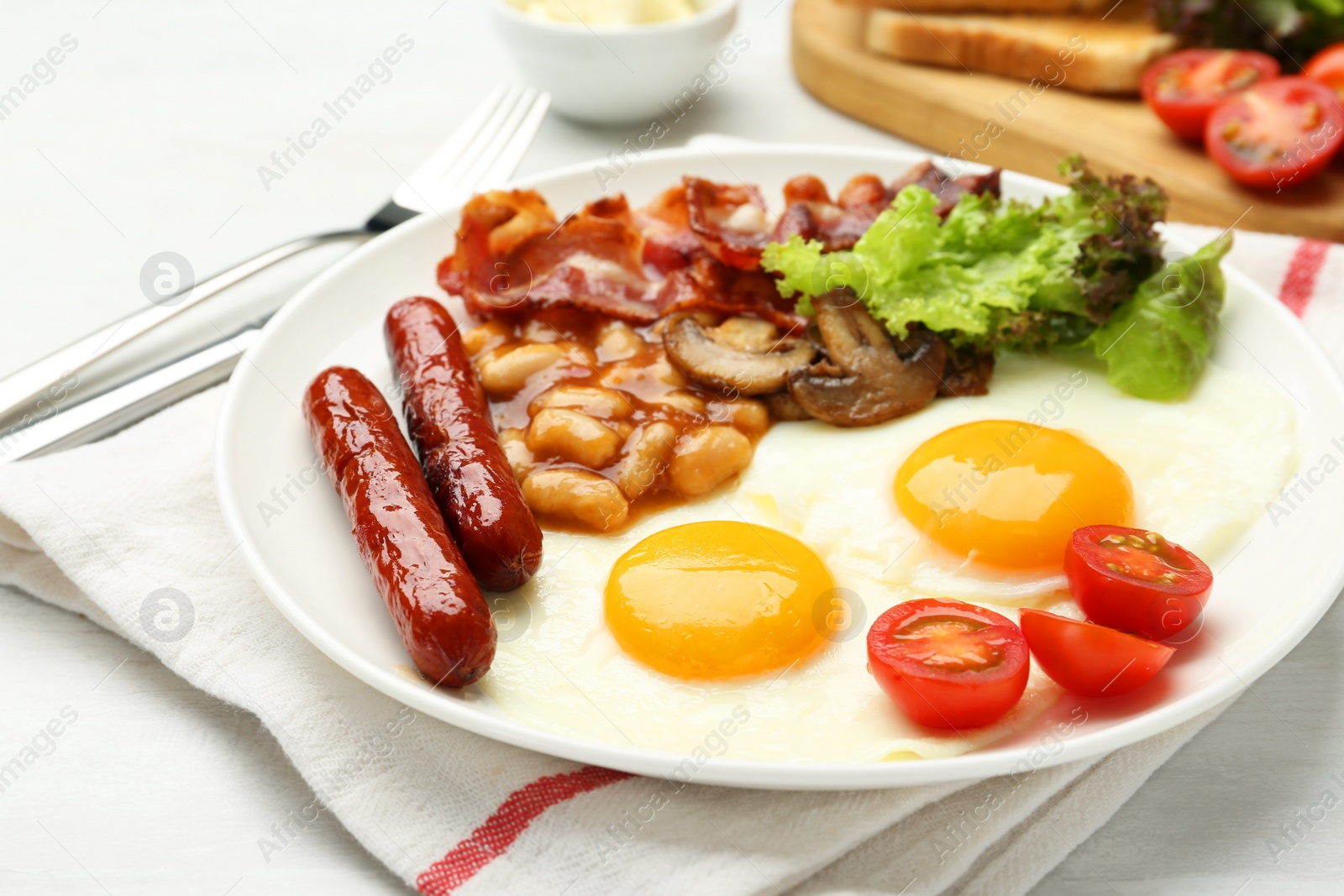 Photo of Delicious breakfast with sunny side up eggs served on white table, closeup